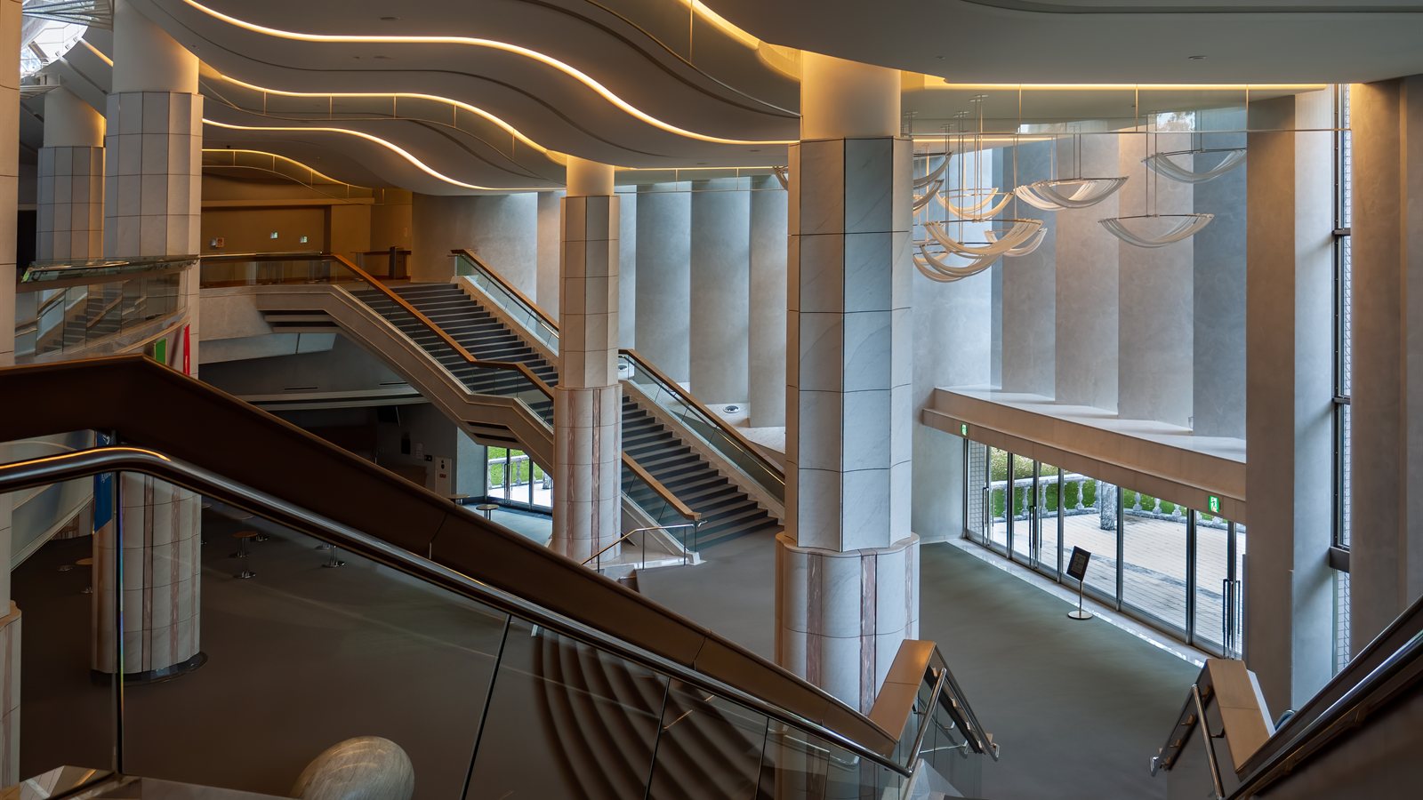 Concert hall foyer with curved timber ceiling forms