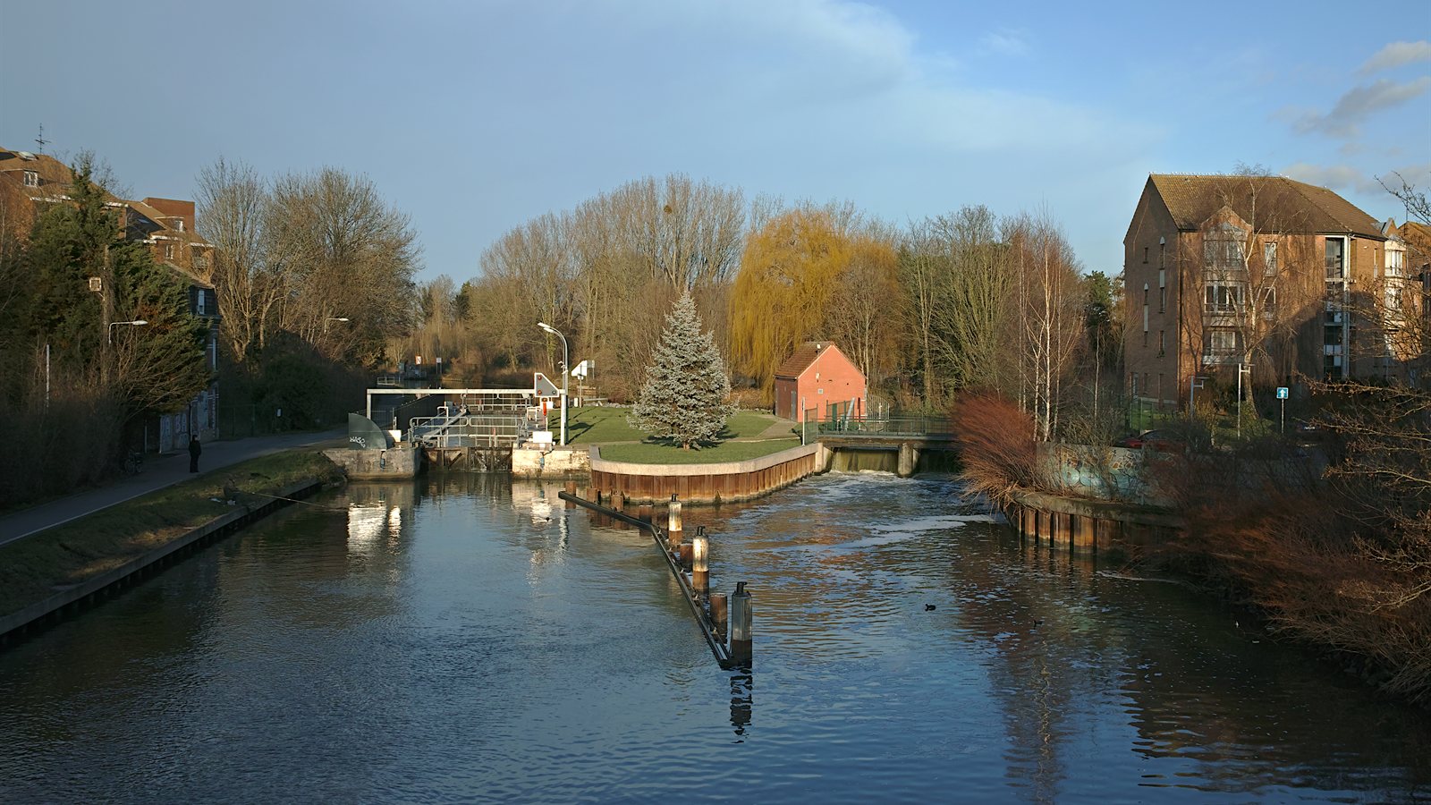 Old canal lock with stone chamber and wooden gates