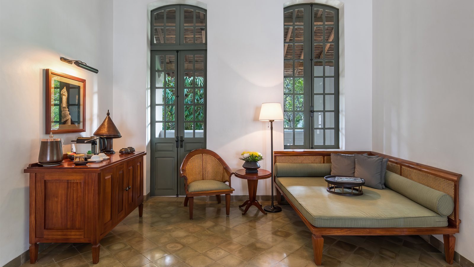 Warmly furnished lounge with tall doors and daybed