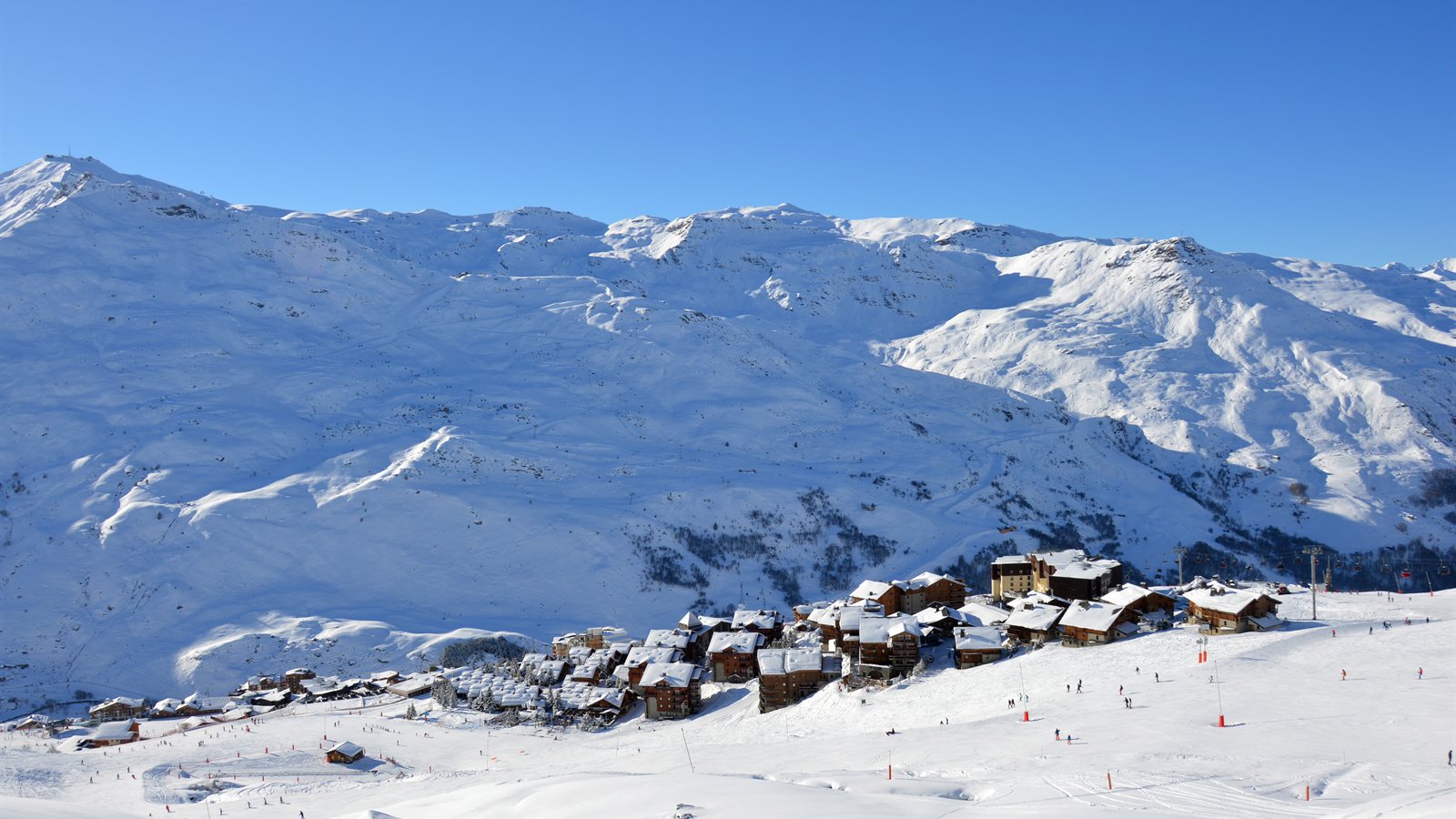 Ski slopes and chalets above a snow-covered resort