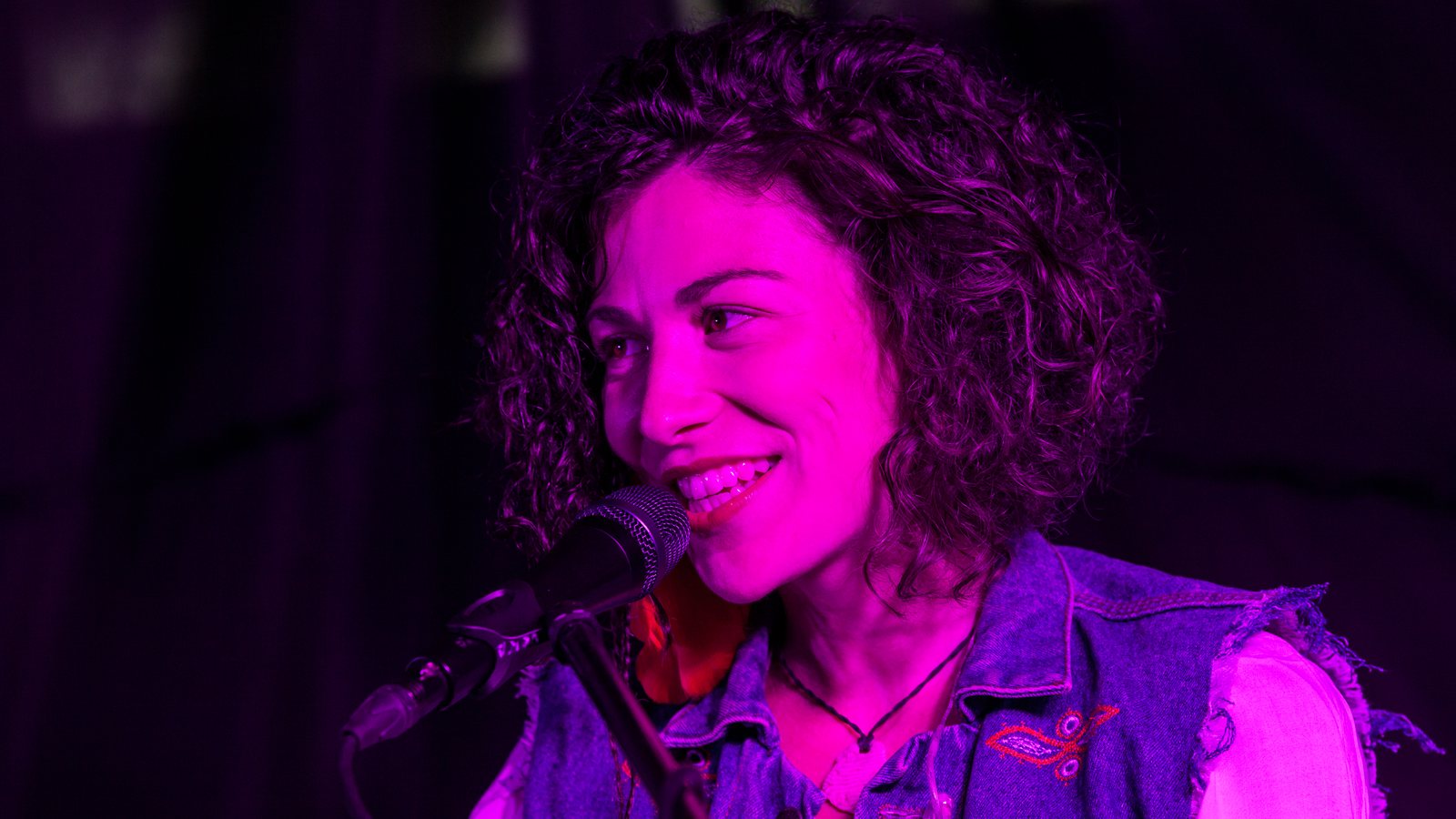 Band on stage bathed in coloured light