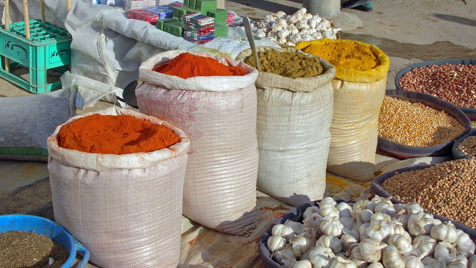Spice stall with open sacks of coloured spices