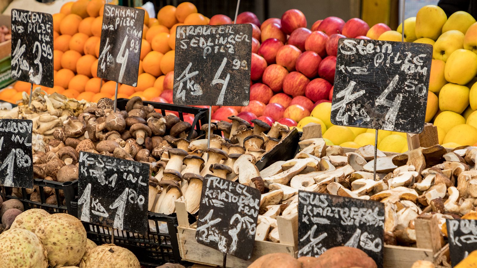 Busy covered market street with food stalls