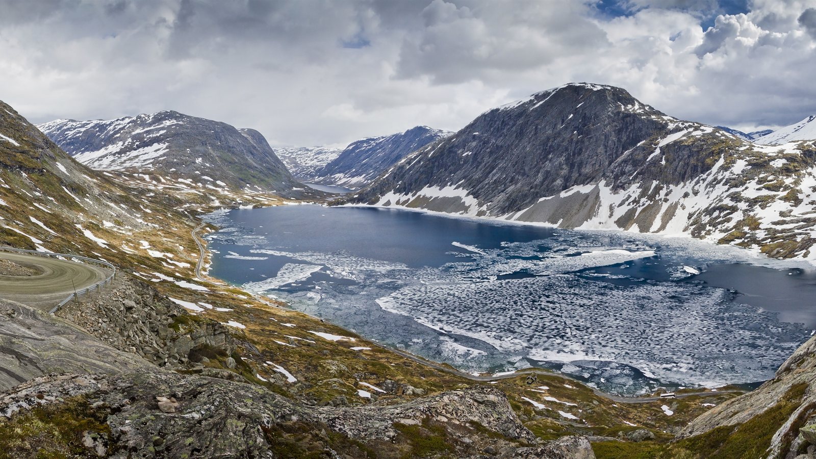 Icy mountain lake seen from a high road
