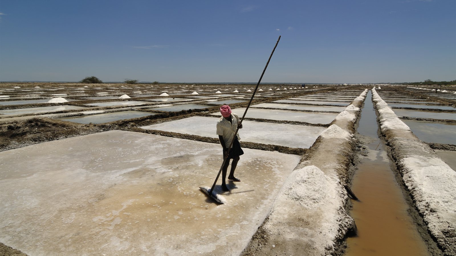 Geometric salt pans reflecting the sky