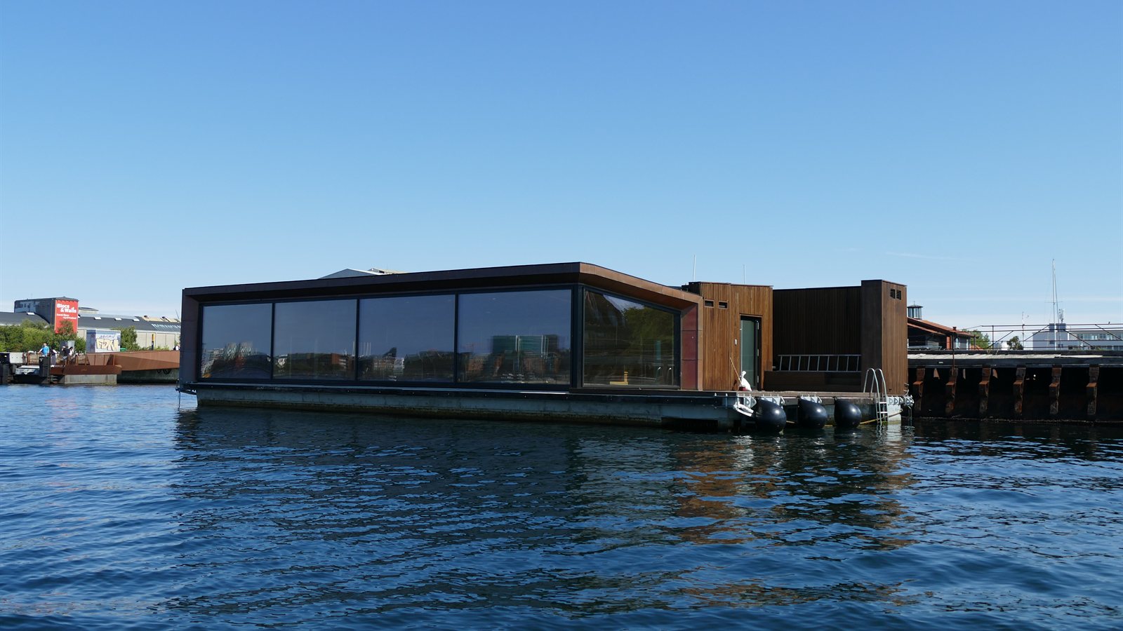 Houseboat with terrace moored on a calm harbour