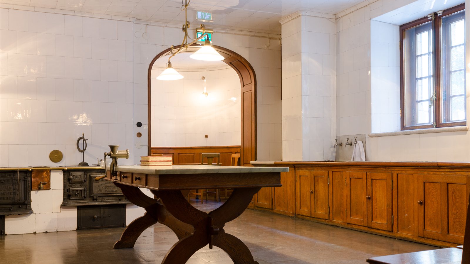 Historic kitchen with fitted cupboards and a long table