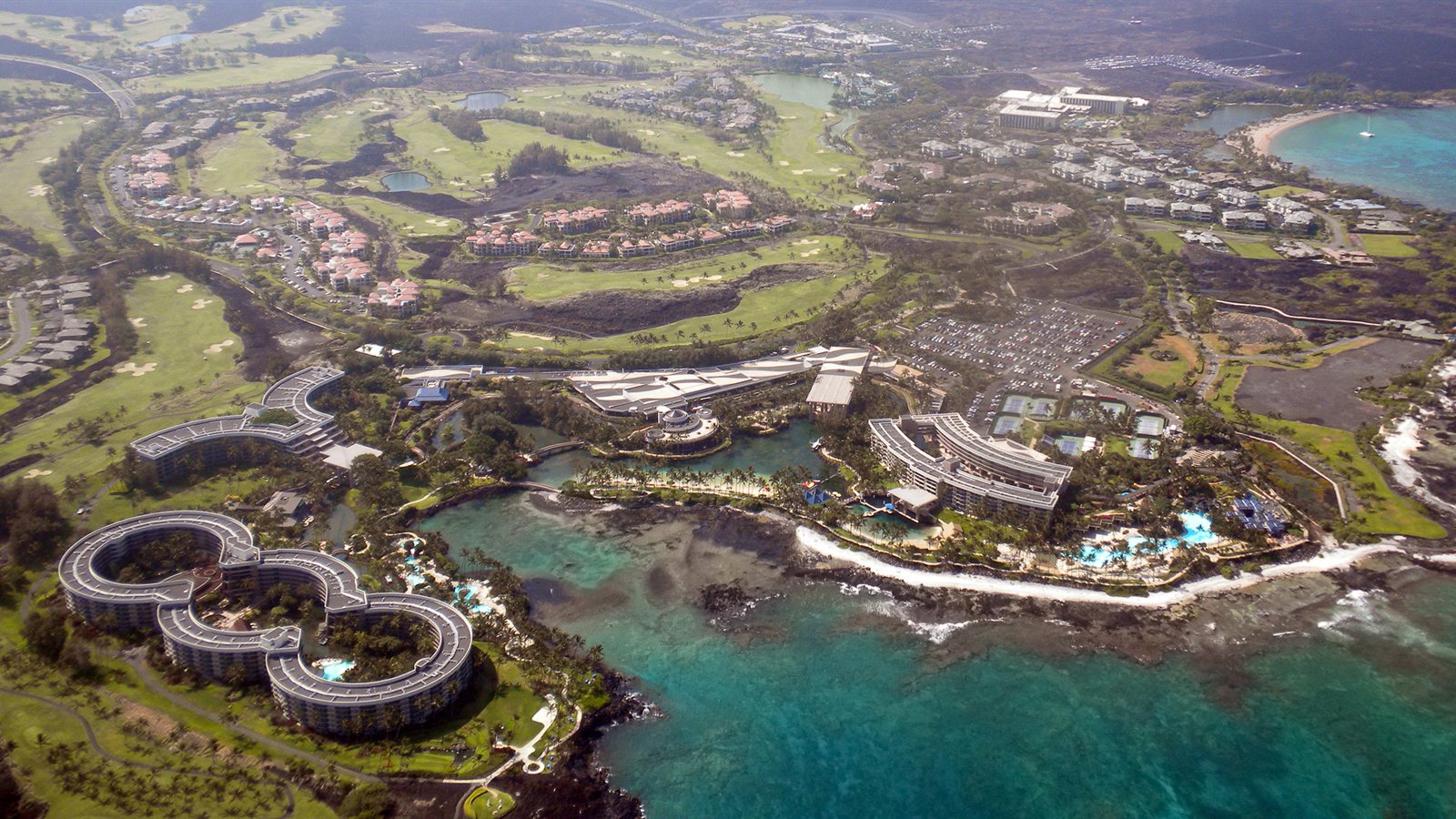 Aerial view of a resort coastline with sheltered bays
