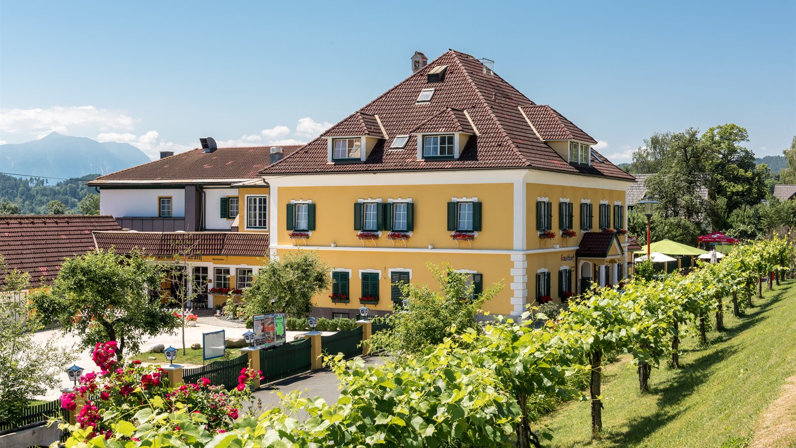 Old country guesthouse with shuttered windows and a tiled roof
