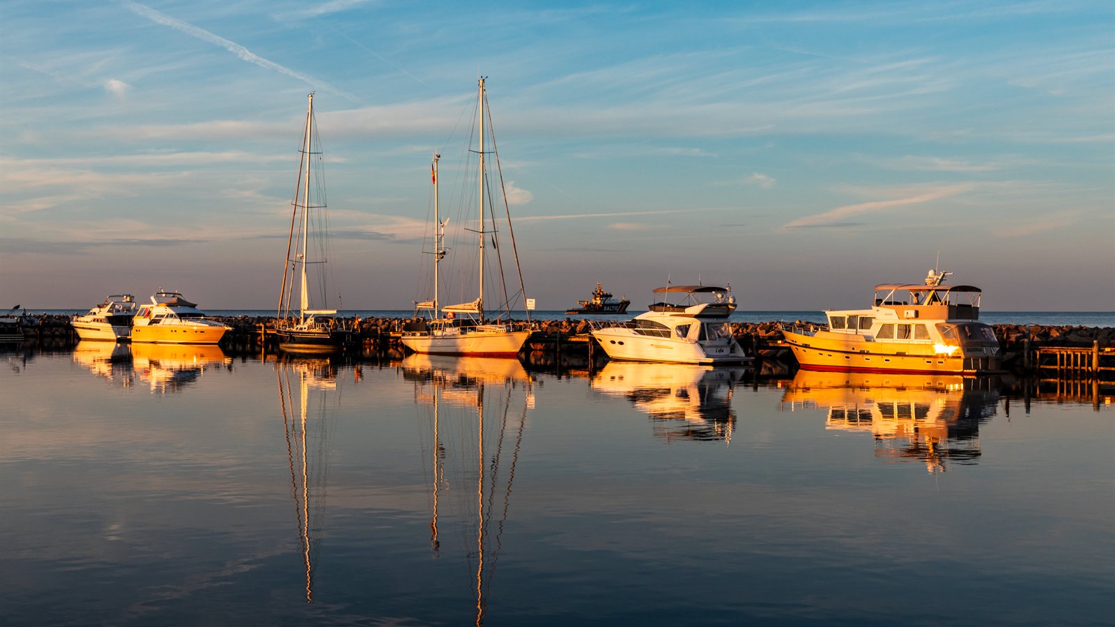 Motor yachts moored in a quiet marina basin