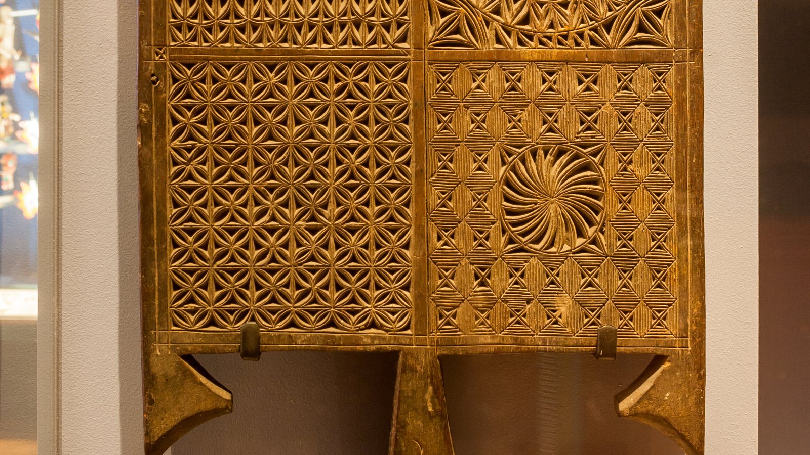 Carved wooden textile printing blocks in a display case