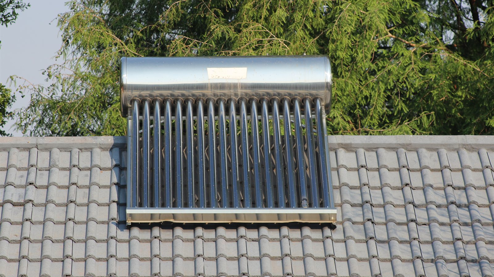Evacuated tube solar collector mounted on a tiled roof