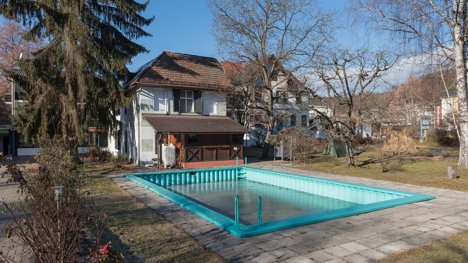 Outdoor swimming pool beside a hotel terrace