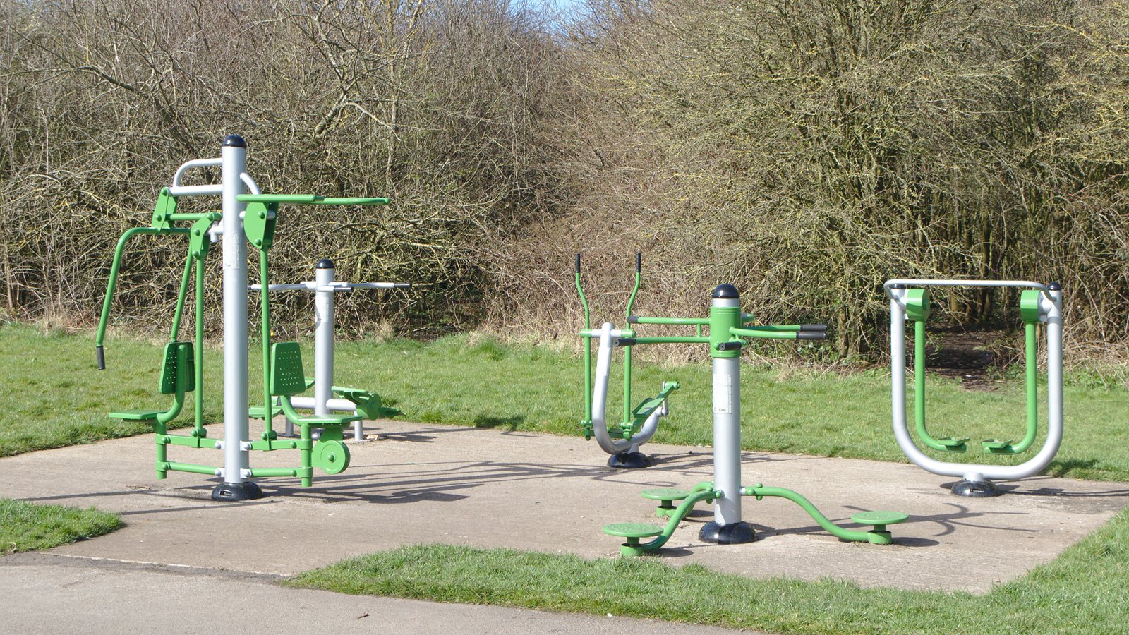 Outdoor exercise equipment installed beside a path