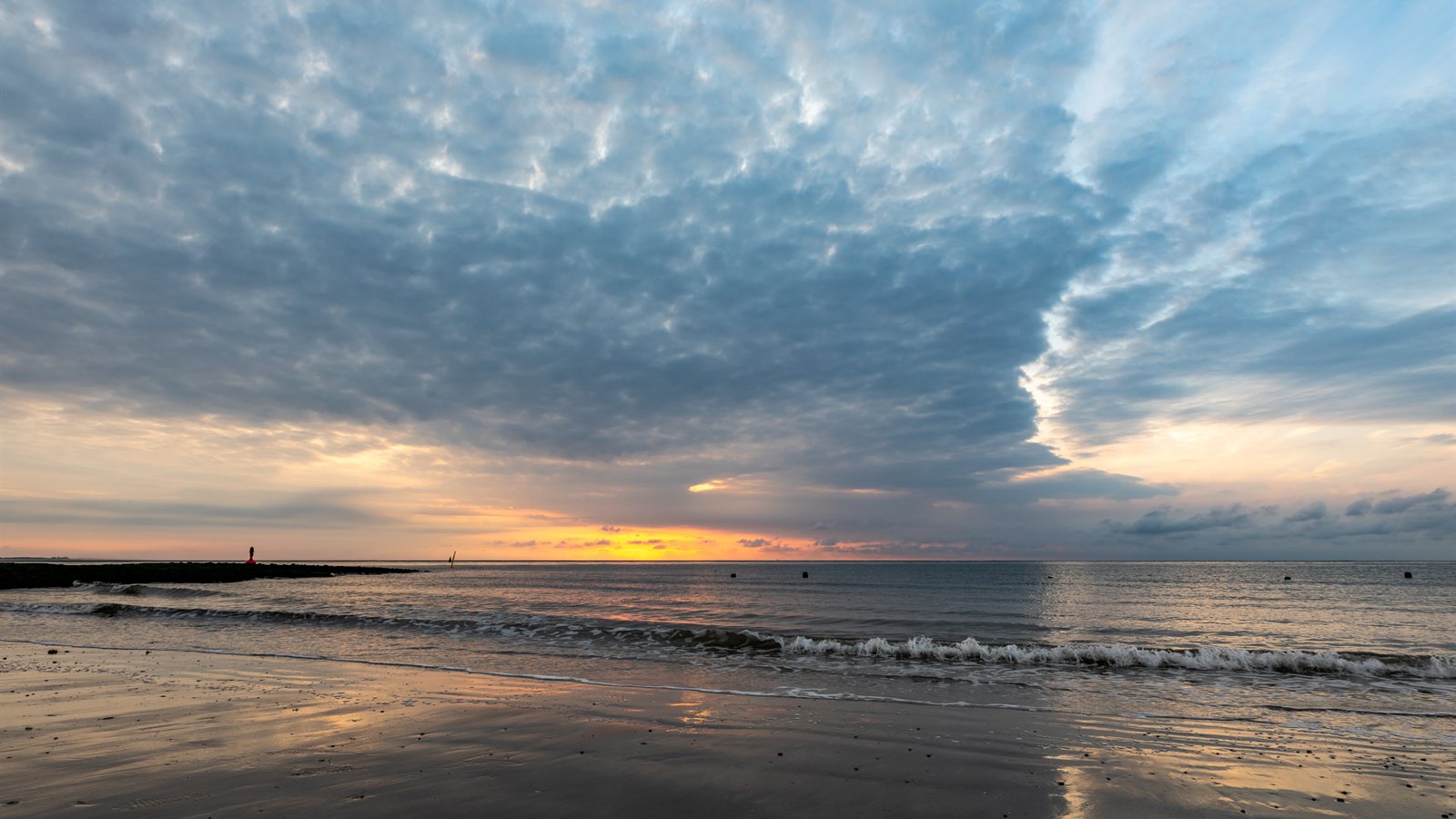 Beach at sunset with the tide out and colour in the sky