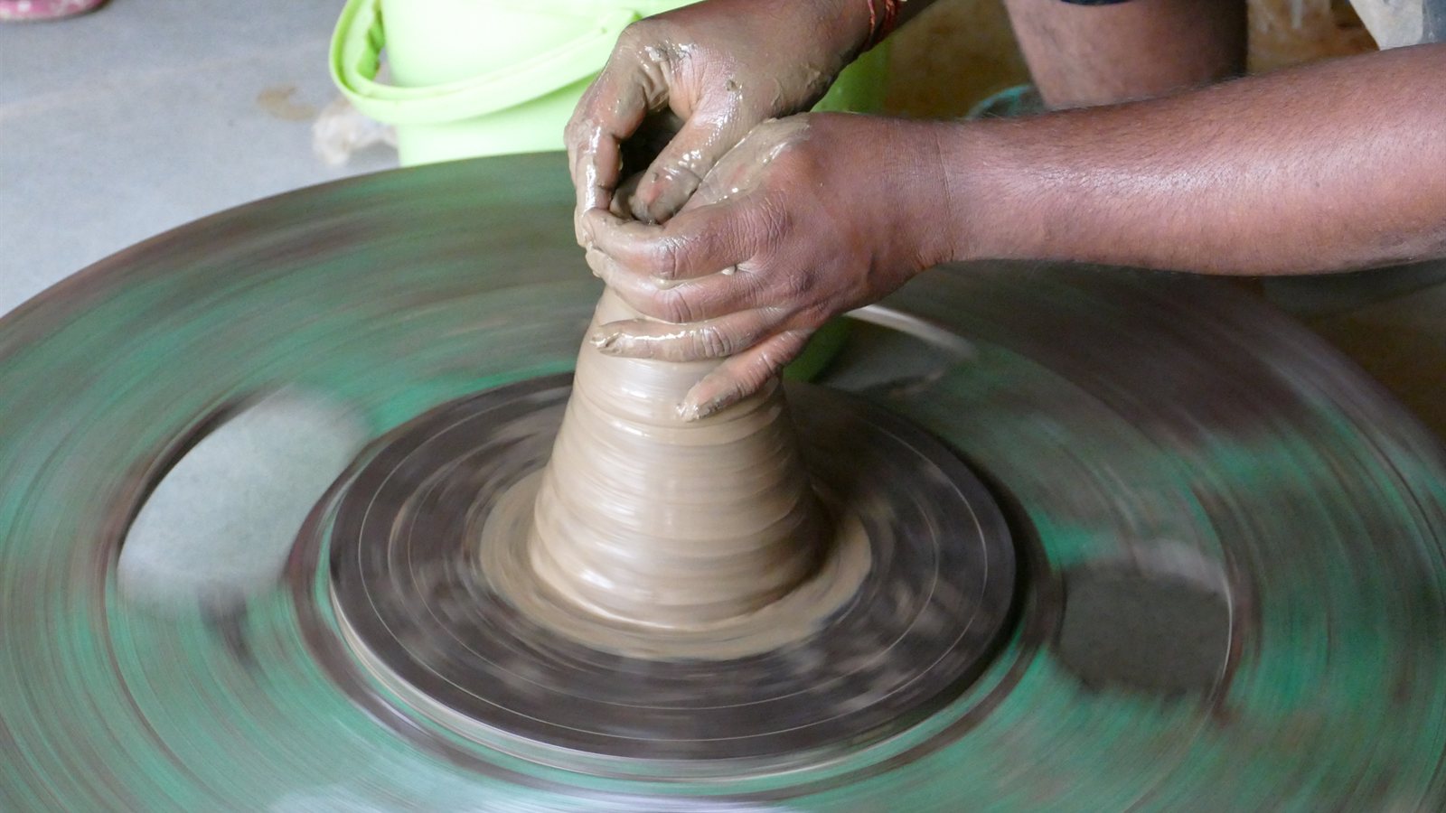 Potter shaping clay in a workshop