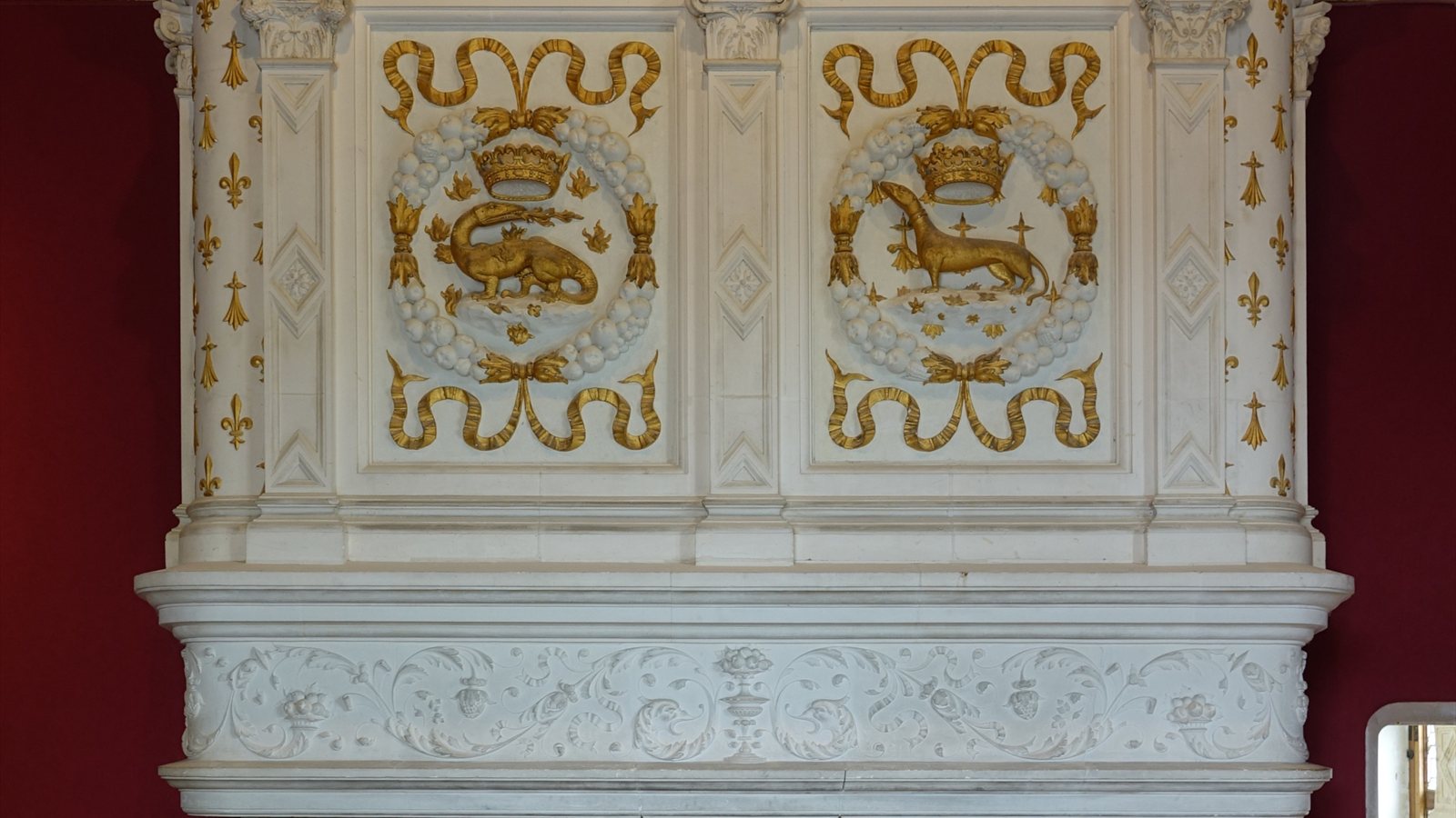 Grand stone fireplace in a panelled historic room