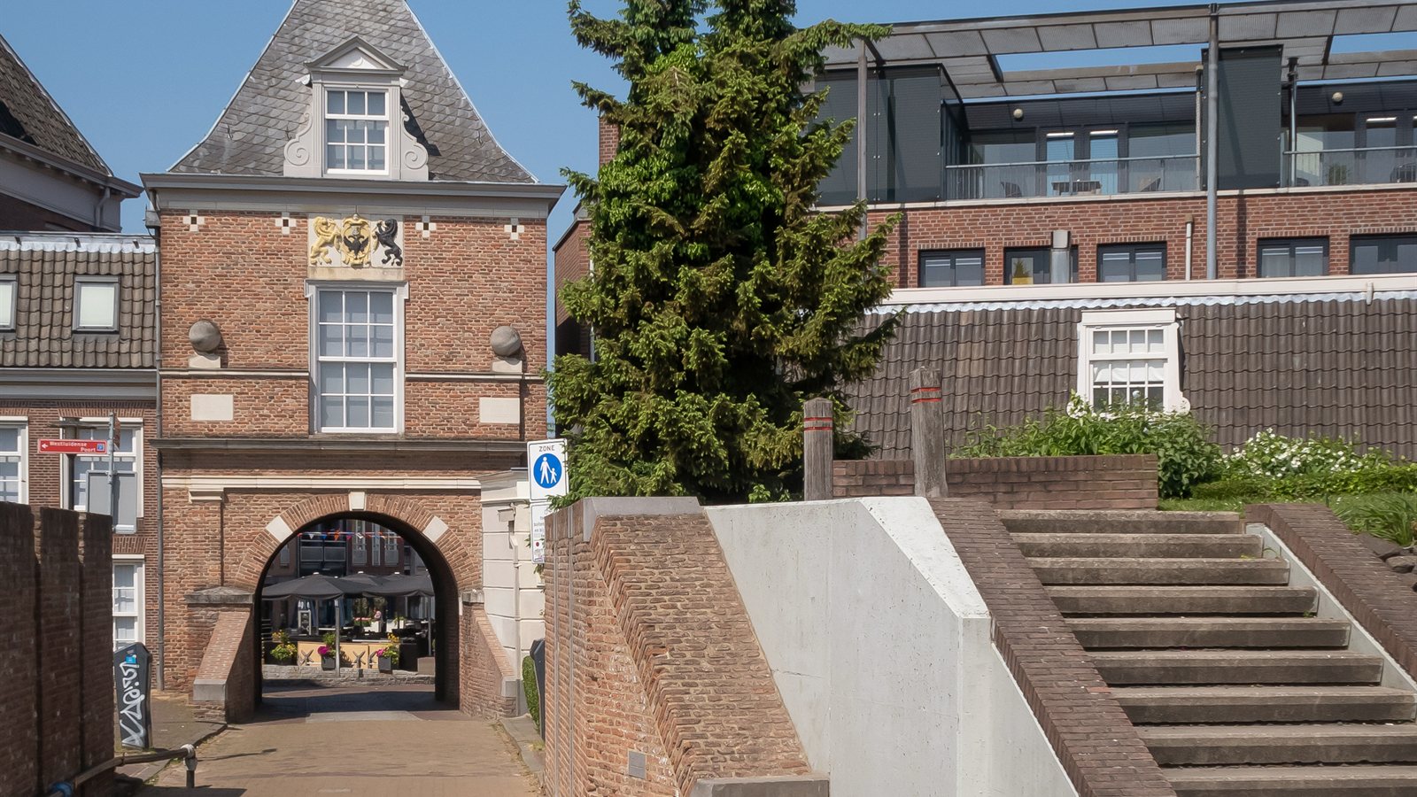 Historic town gate and brick steps leading down to the harbour