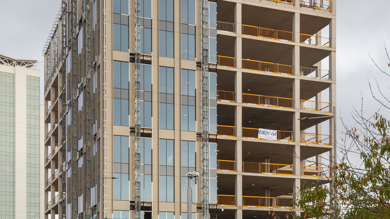 Office building under construction behind hoardings