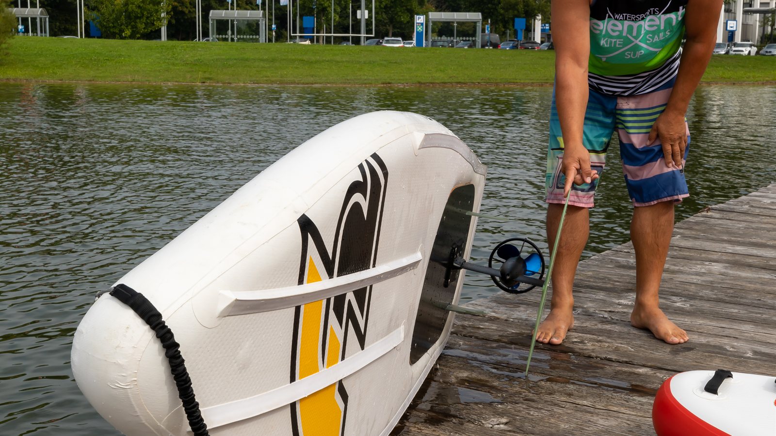 Boards displayed on stands at a watersports show