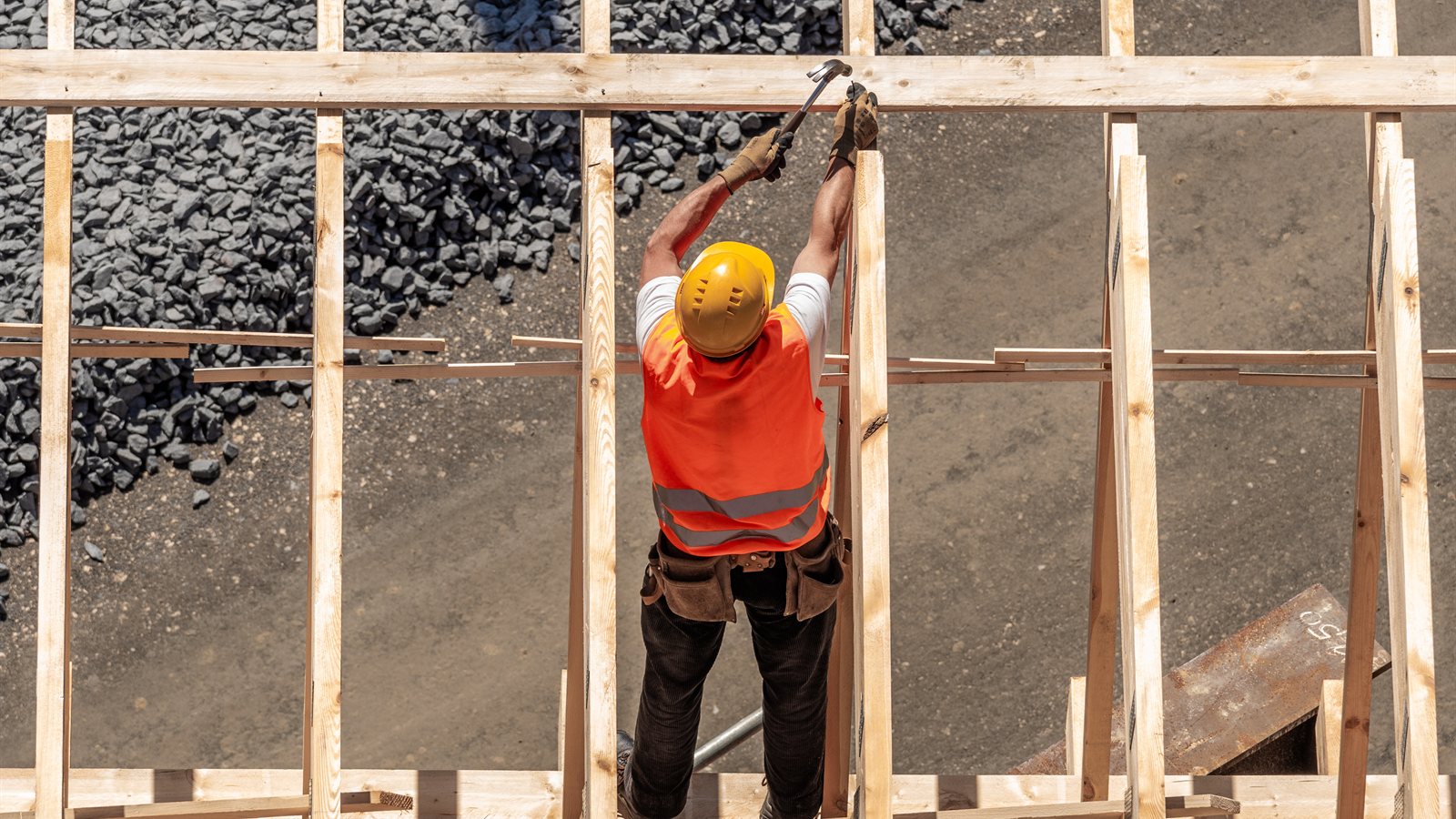 Carpenter working on timber formwork at height